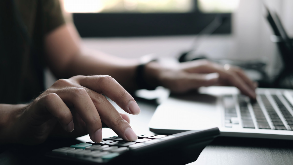 Photo of persons hand on a computer keyboard.