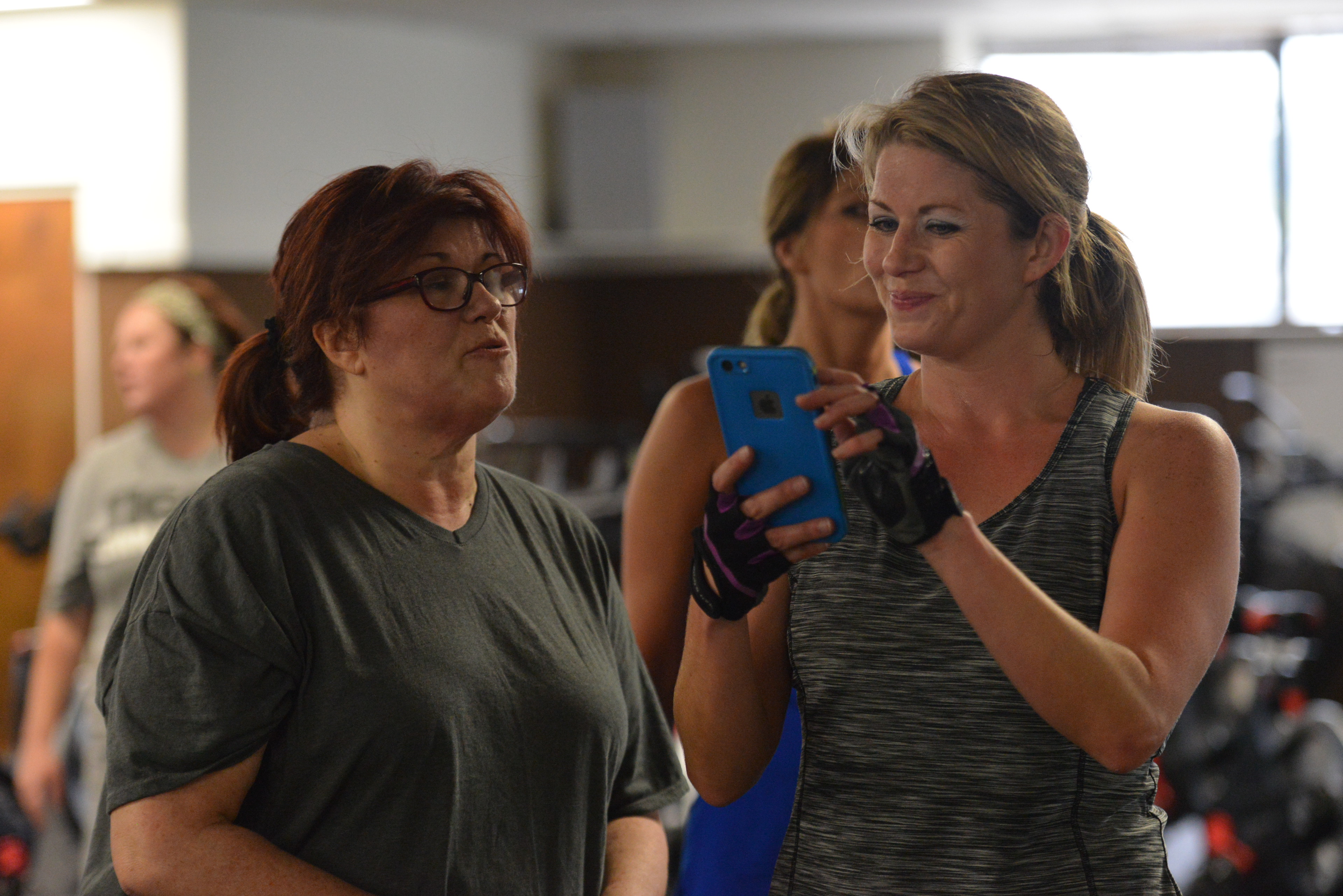 Photo of smiling people participating in a fitness class.