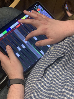 person using iPad to control lighting for a concert